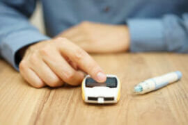 Man checking blood glucouse meter