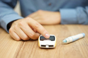 Man checking blood glucouse meter