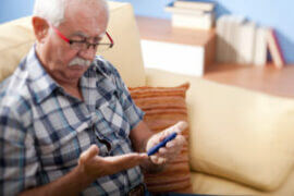 Older man checking blood sugar