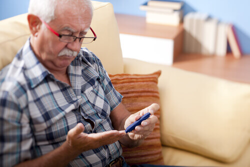 Older man checking blood sugar levels