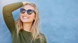 Woman in sunglasses looking up