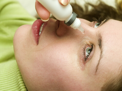 Woman using eyedrops