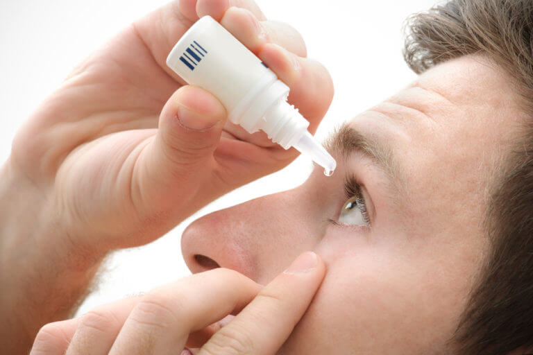 man with eyedrops