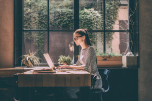 woman on laptop at kitchen table