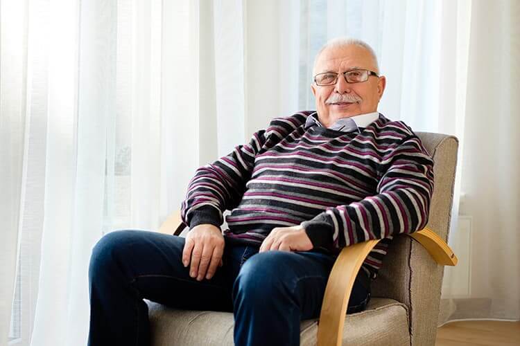 Older man sitting in chair